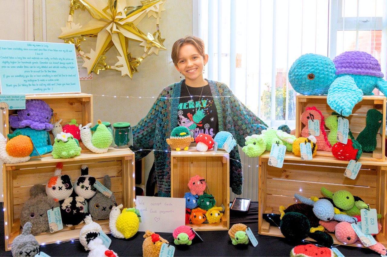 Teenager selling her homemade crafts at a teenage market event