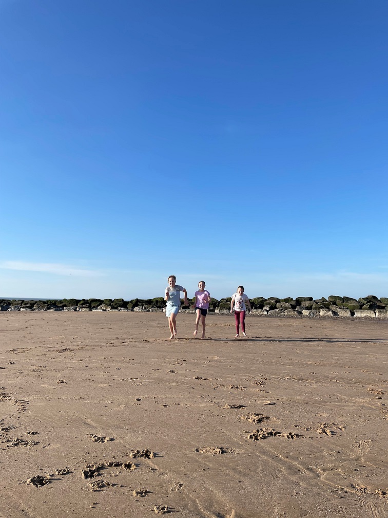 Children running on the beach