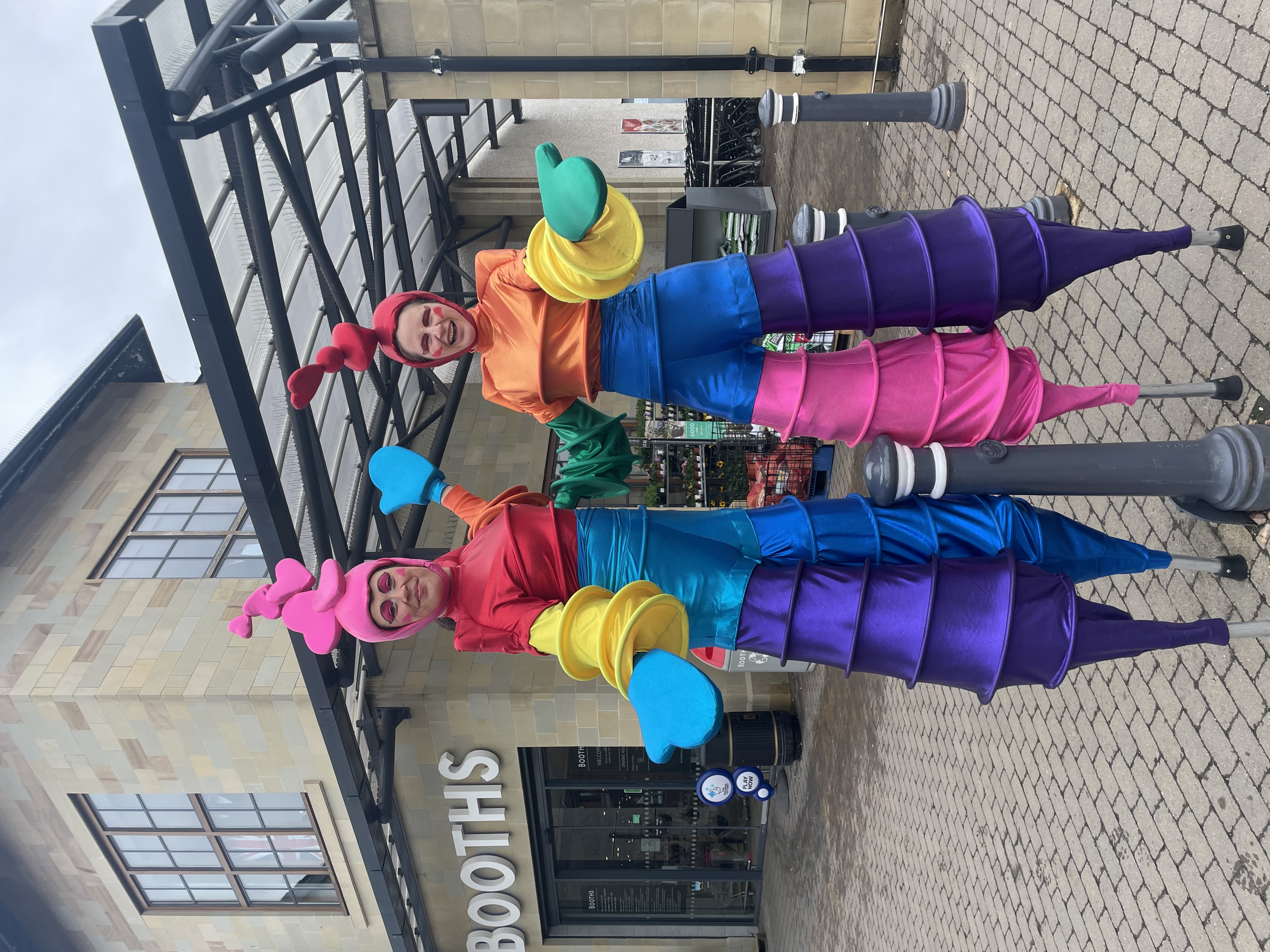 rainbow stilt walkers