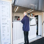 Man ordering food at fish and chip stall