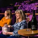 People sitting at the cinema eating popcorn