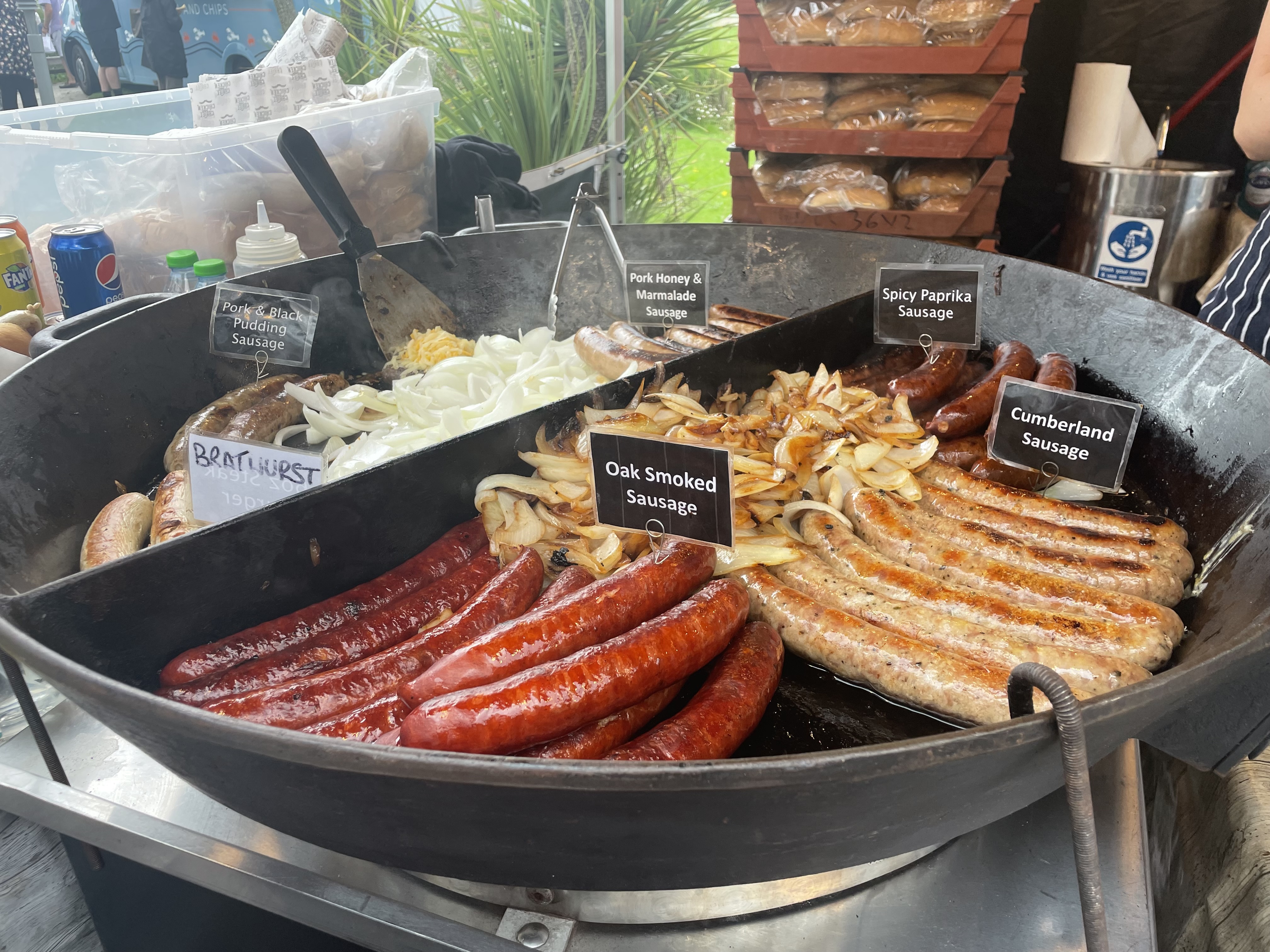 Sausages frying in a pan