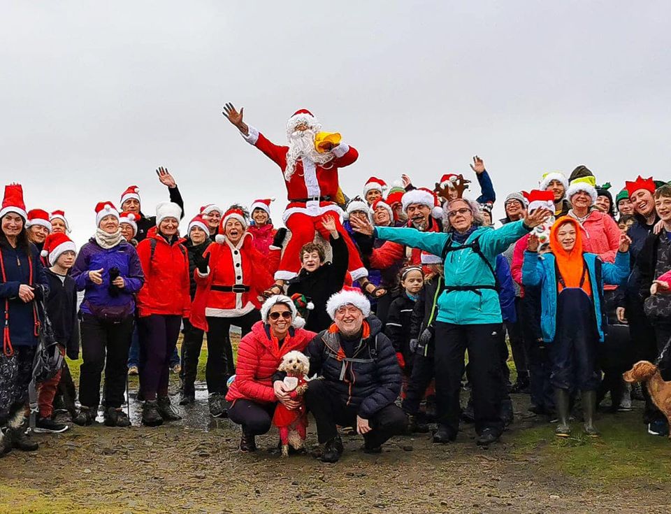 People at the top of Nicky Nook wearing Santa hats