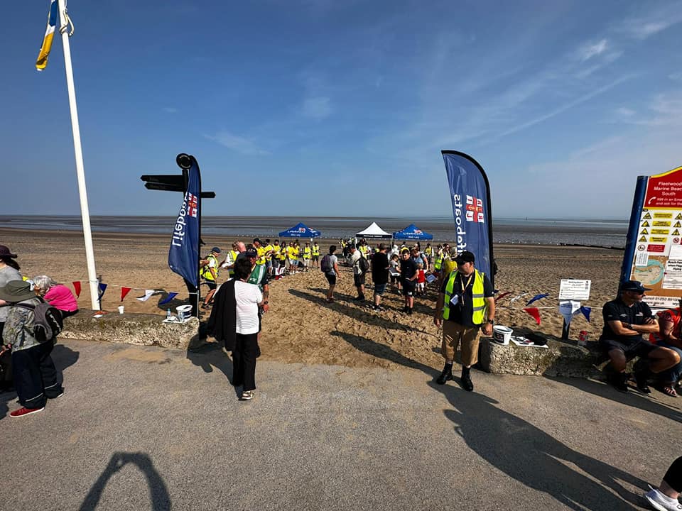 People walking onto Fleetwood beach