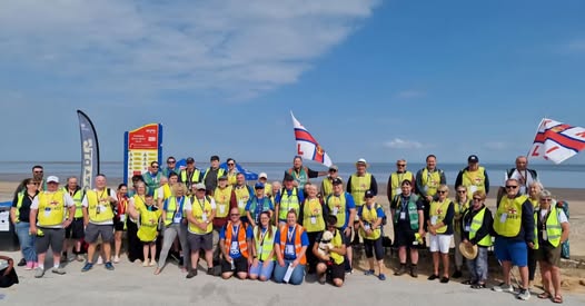 Participants of RNLI Fleetwood Wreck Trek smiling at camera