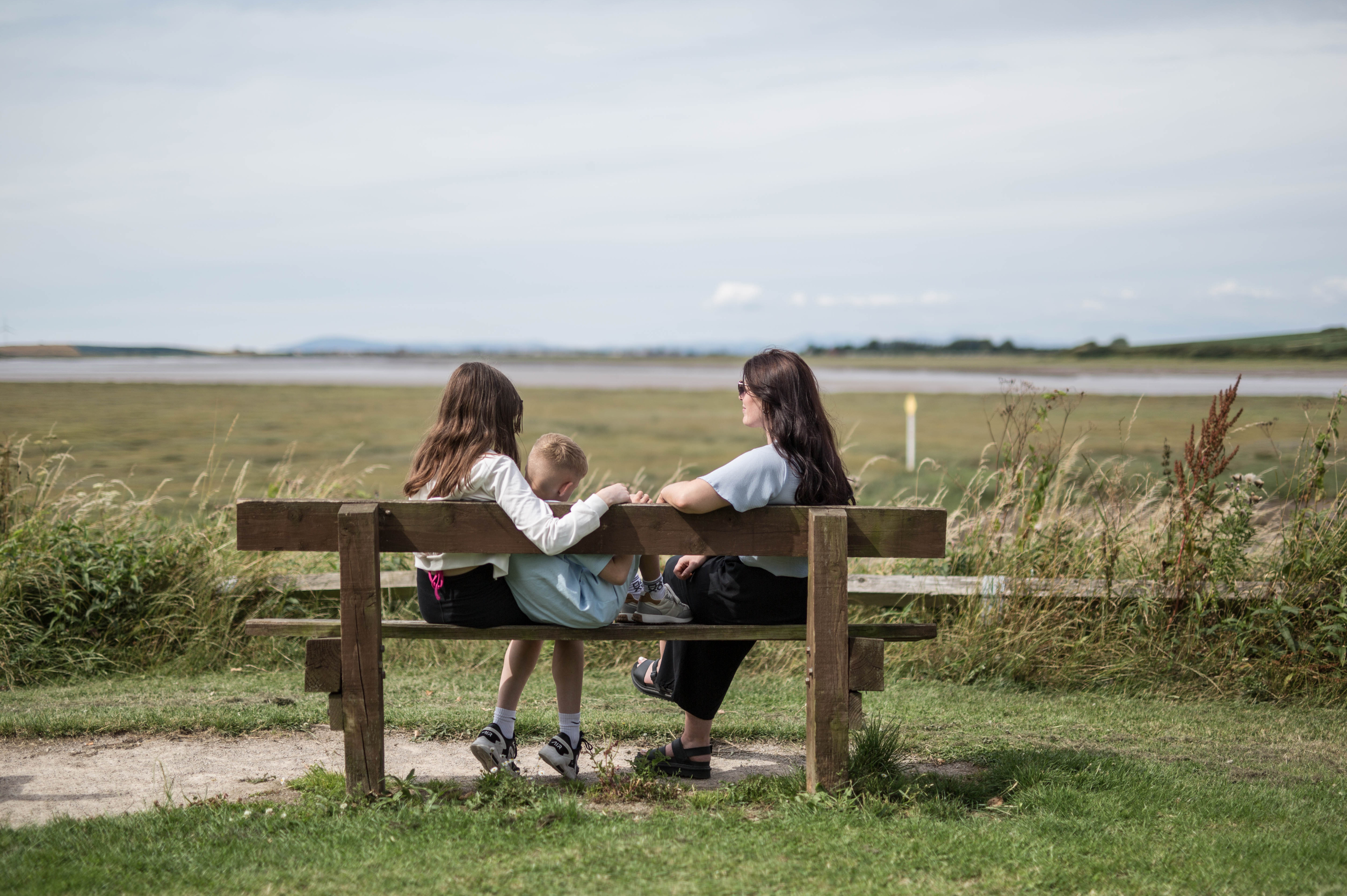People chatting on a bench at Wyre Estuary Country Park