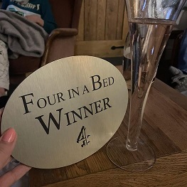 Four in a Bed winner plaque held in hand